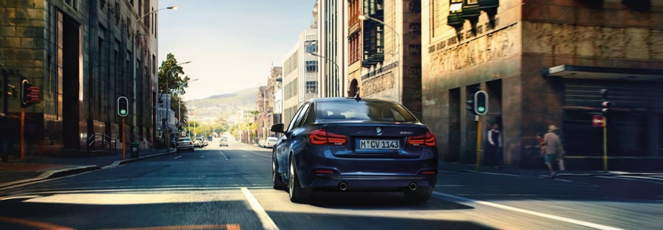 Blue 2019 BMW 3 Series sedan driving down the street