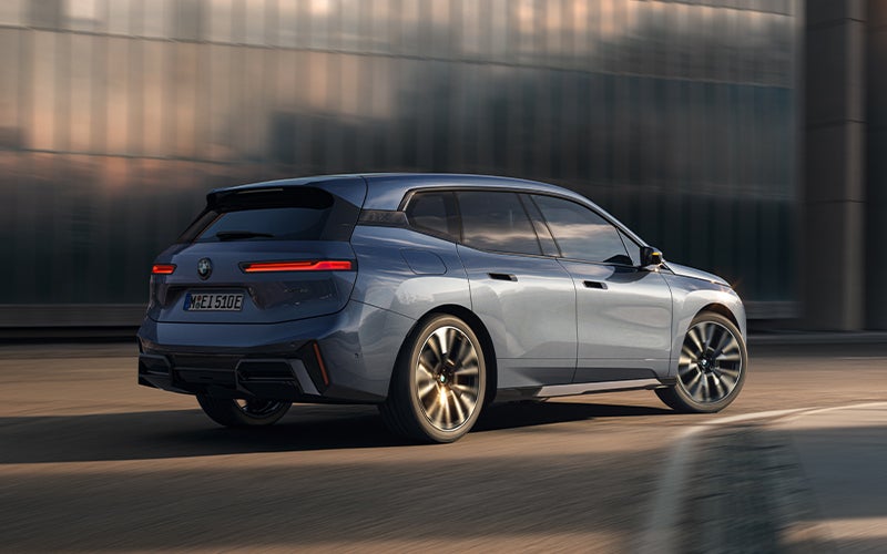 The BMW iX driving with the front wheel turned. | BMW of Madison in Madison WI